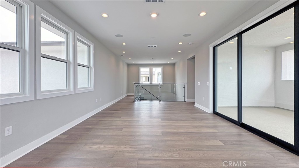 217 Stage Irvine, CA 92618 - Photo 20 of 26 a view of an empty room with wooden floor and a window