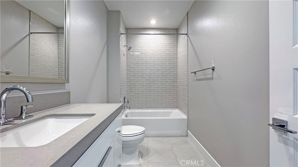 217 Stage Irvine, CA 92618 - Photo 22 of 26 a bathroom with a sink a toilet and shower