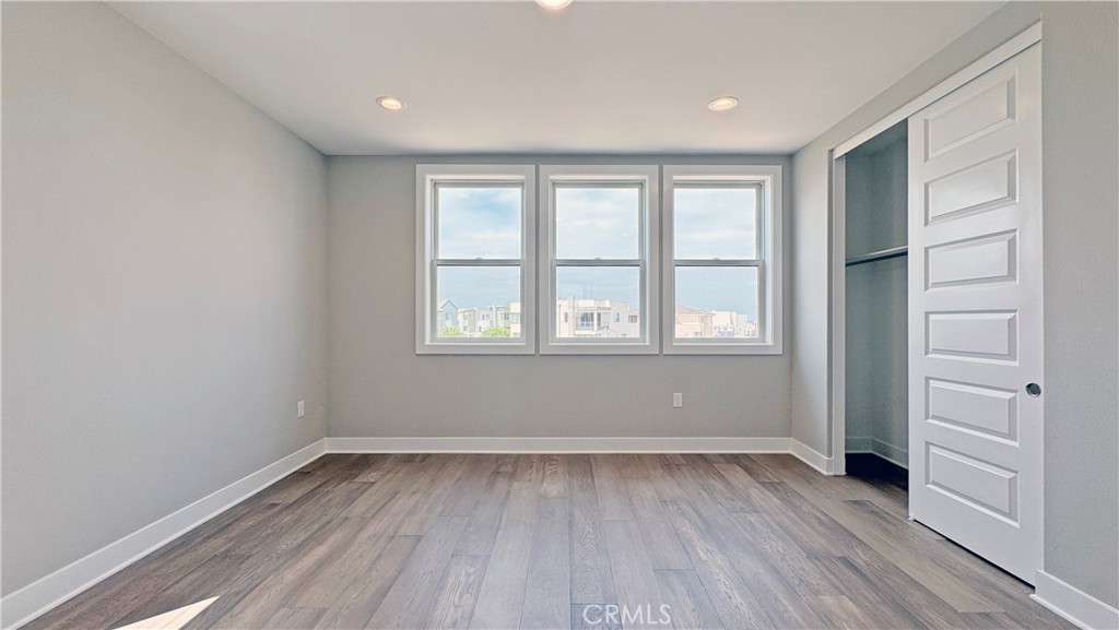 217 Stage Irvine, CA 92618 - Photo 24 of 26 an empty room with wooden floor and windows