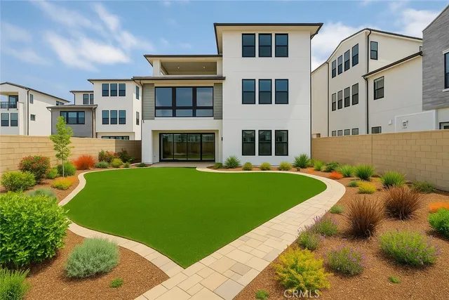 a front view of a house with a garden and yard
