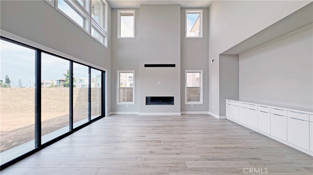 217 Stage Irvine, CA 92618 - Photo 4 of 26 a view of an empty room with window and wooden floor