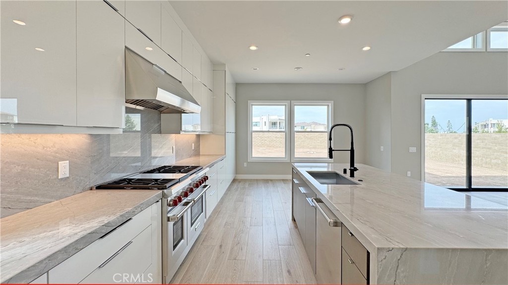 217 Stage Irvine, CA 92618 - Photo 8 of 26 a kitchen with stainless steel appliances granite countertop a sink stove and cabinets