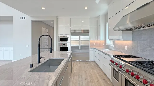 a kitchen with stainless steel appliances granite countertop a stove and a refrigerator