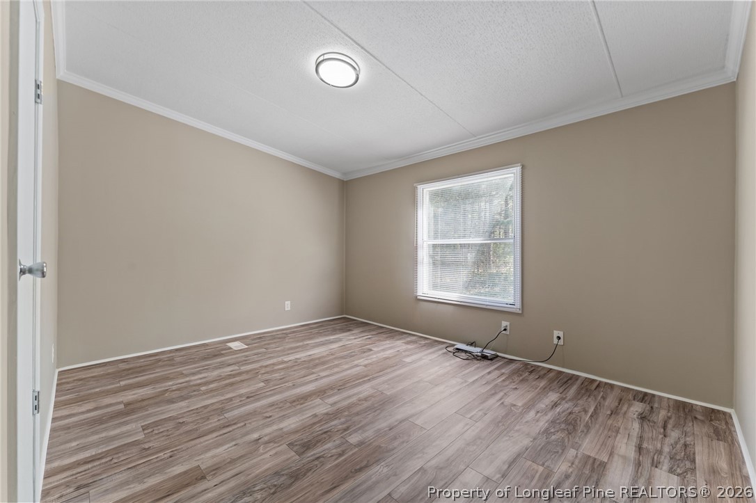 515 Mt Zion Road Red Springs, NC 28377 - Photo 21 of 50 a view of an empty room with wooden floor and a window