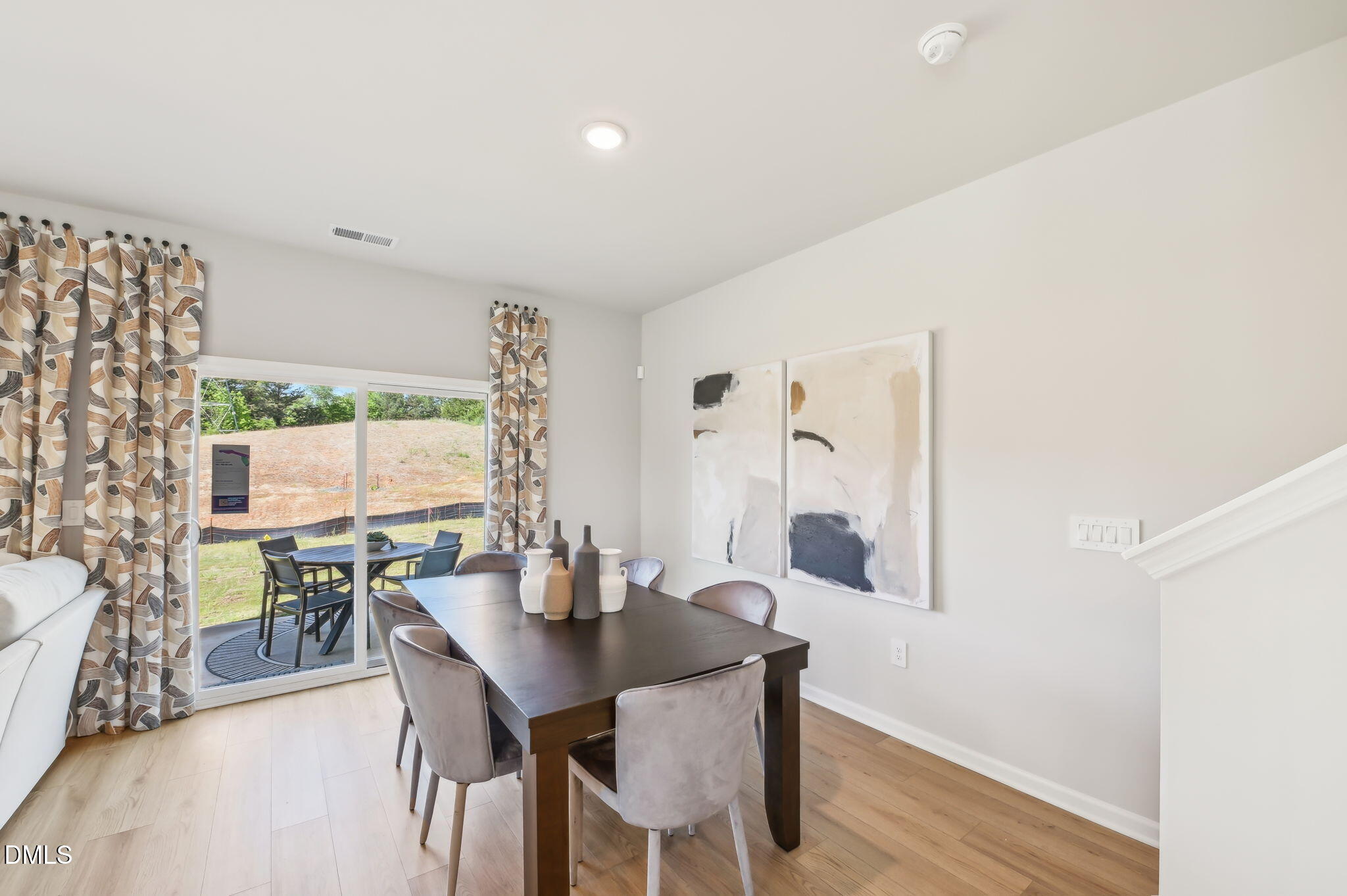 924 Broadleaf Trace Mebane, NC 27302 - Photo 10 of 26 a view of a dining room with furniture and wooden floor