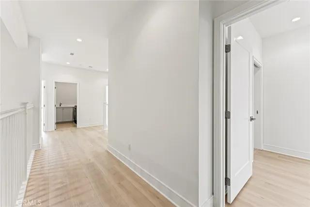 a view of a hallway with a kitchen