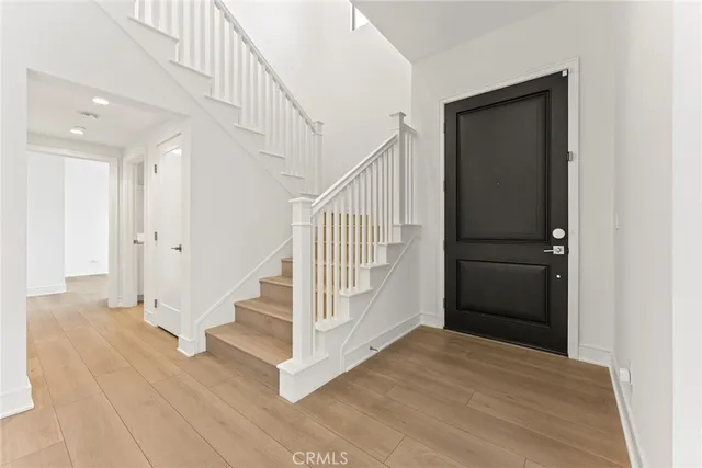 a view of entryway and hall with wooden floor