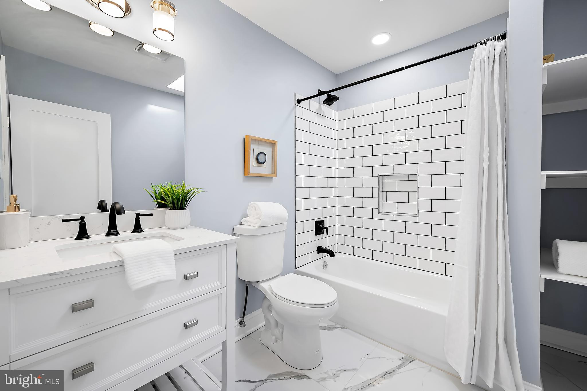 3137 Keswick Road Baltimore, MD 21211 - Photo 17 of 31 a bathroom with a sink toilet and shower