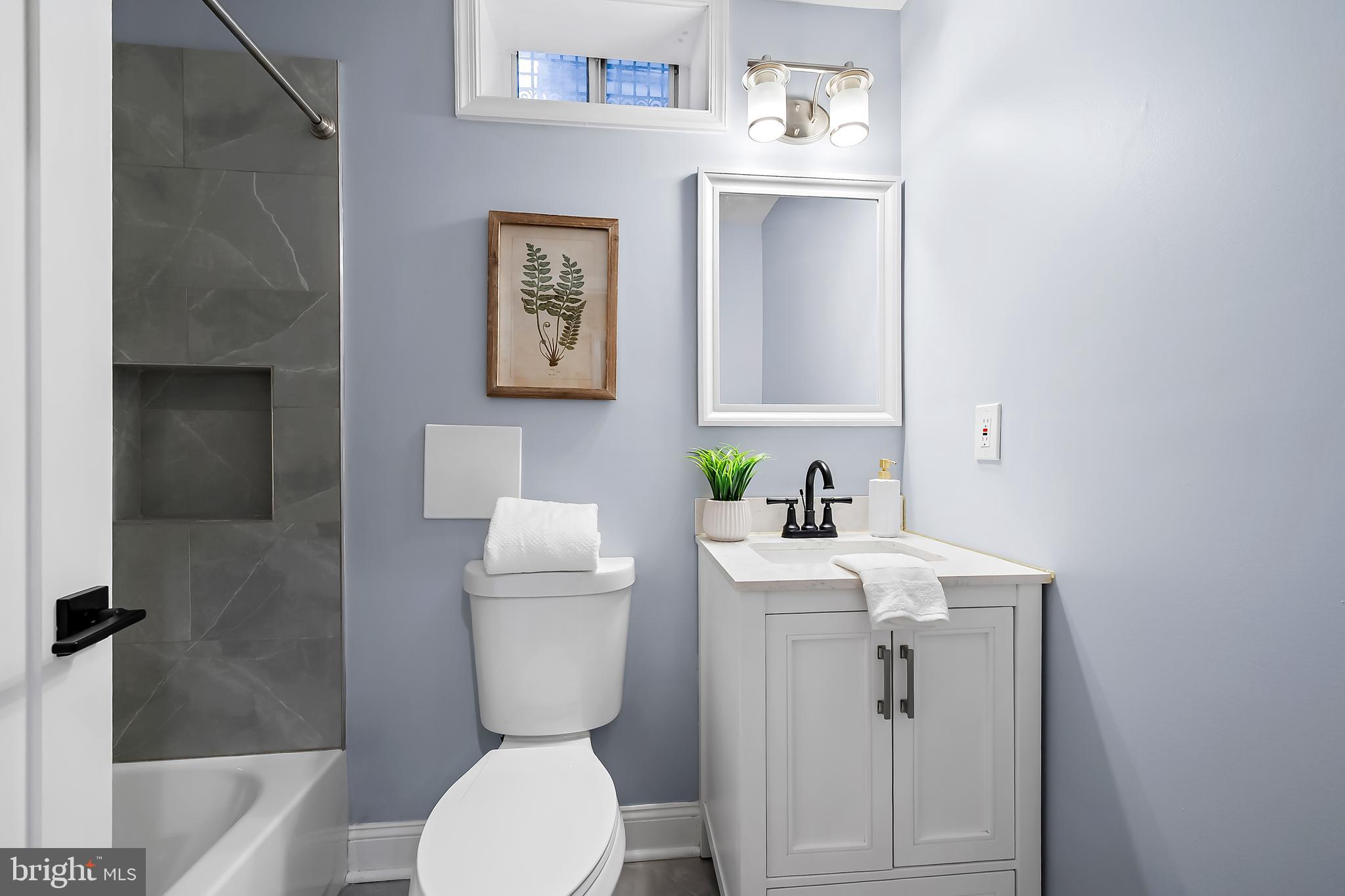 3137 Keswick Road Baltimore, MD 21211 - Photo 23 of 31 a bathroom with a sink a toilet and shower