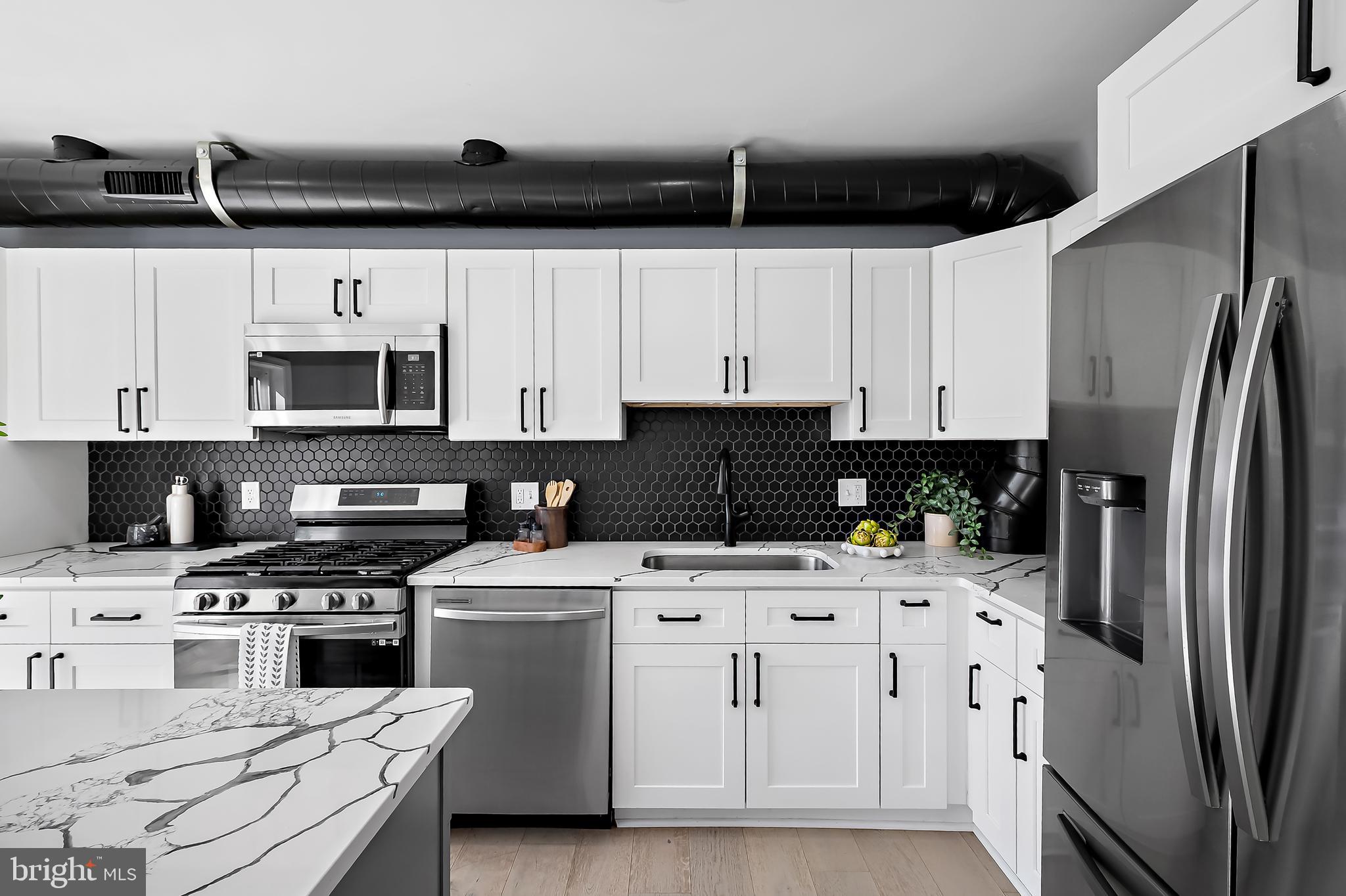 3137 Keswick Road Baltimore, MD 21211 - Photo 6 of 31 a kitchen with cabinets stainless steel appliances and a counter space