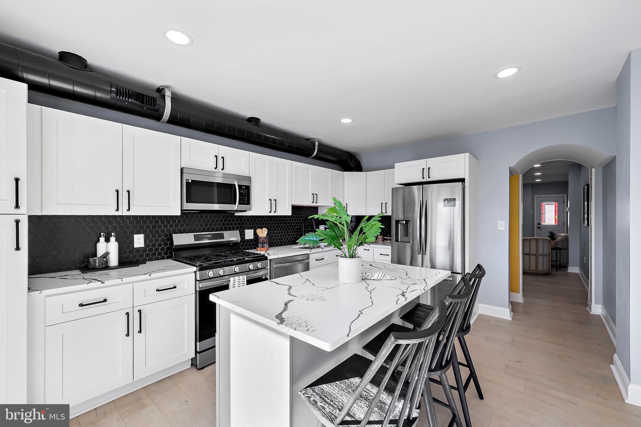 3137 Keswick Road Baltimore, MD 21211 - Photo 9 of 31 a kitchen with a sink a microwave and cabinets