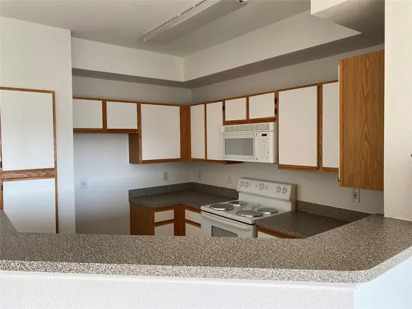 a kitchen with a stove a sink and a refrigerator