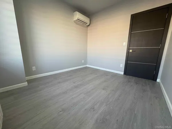 an empty room with wooden floor