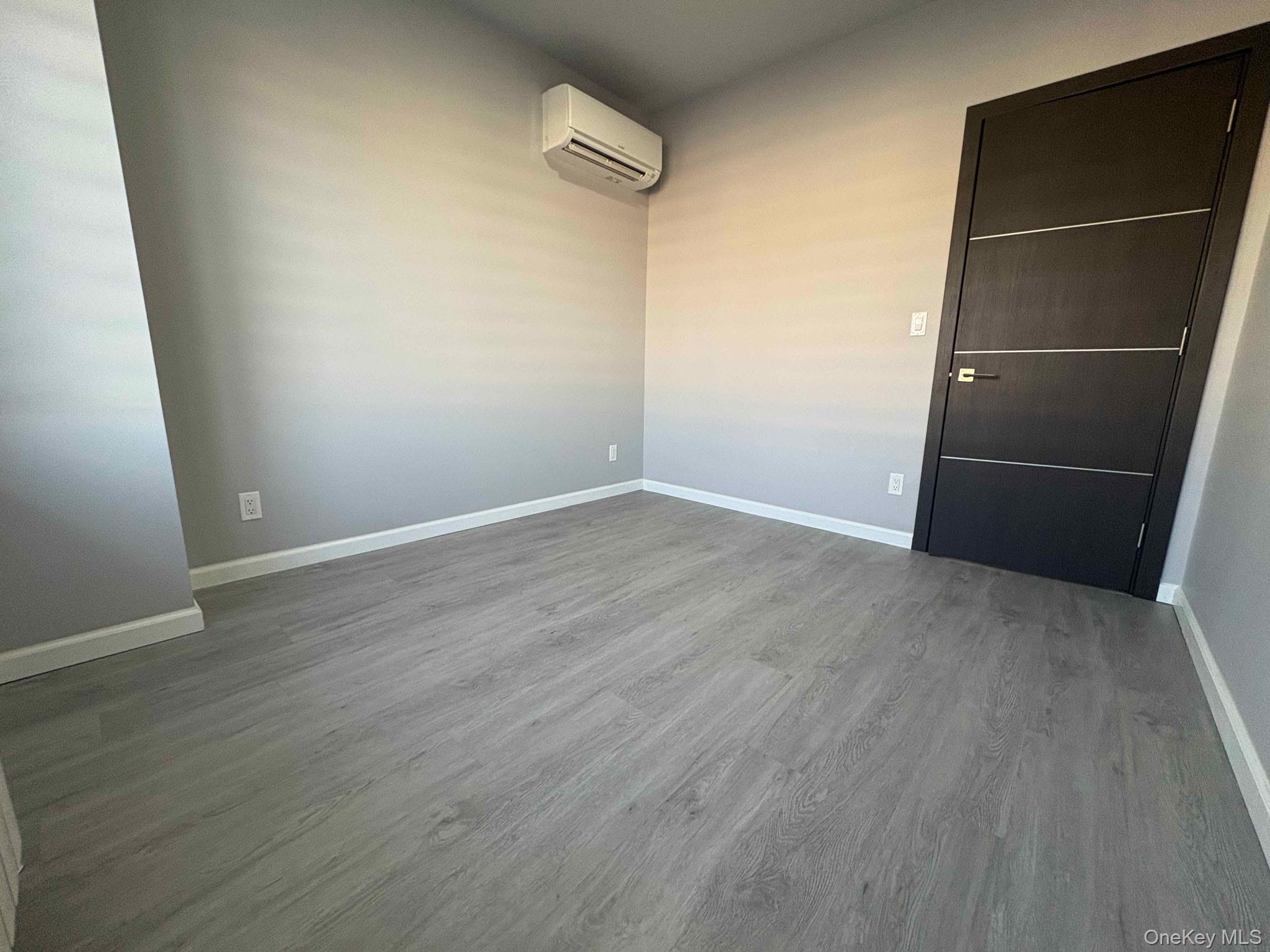 58-46 Fresh Pond Road, Unit 2 Queens, NY 11378 - Photo 2 of 9 an empty room with wooden floor