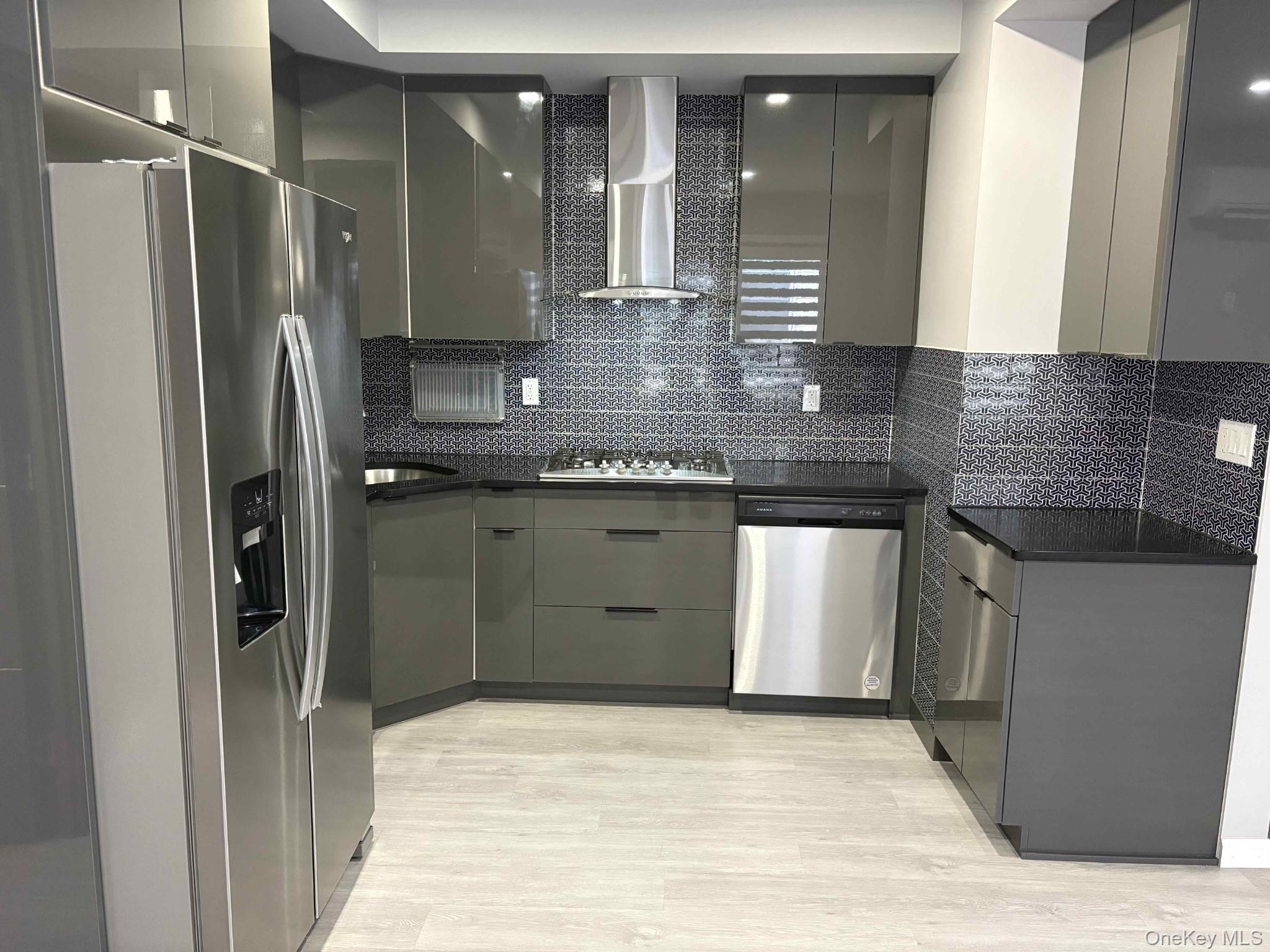 58-46 Fresh Pond Road, Unit 2 Queens, NY 11378 - Photo 5 of 9 a kitchen with stainless steel appliances granite countertop a refrigerator and a sink