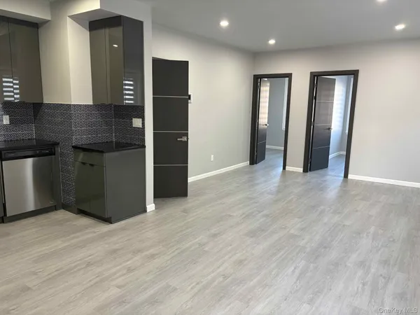 a view of wooden floor and windows in a room