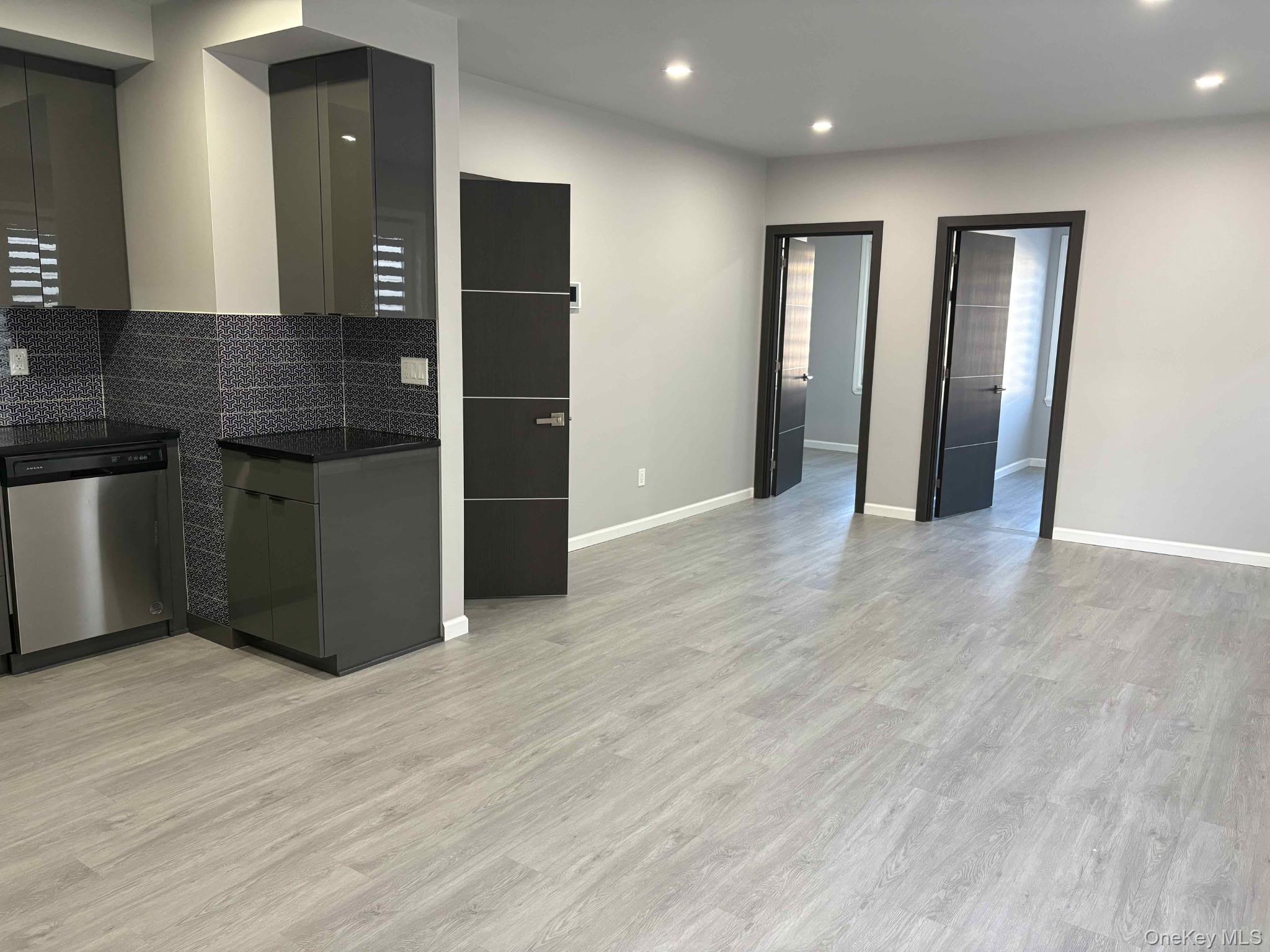 58-46 Fresh Pond Road, Unit 2 Queens, NY 11378 - Photo 6 of 9 a view of wooden floor and windows in a room