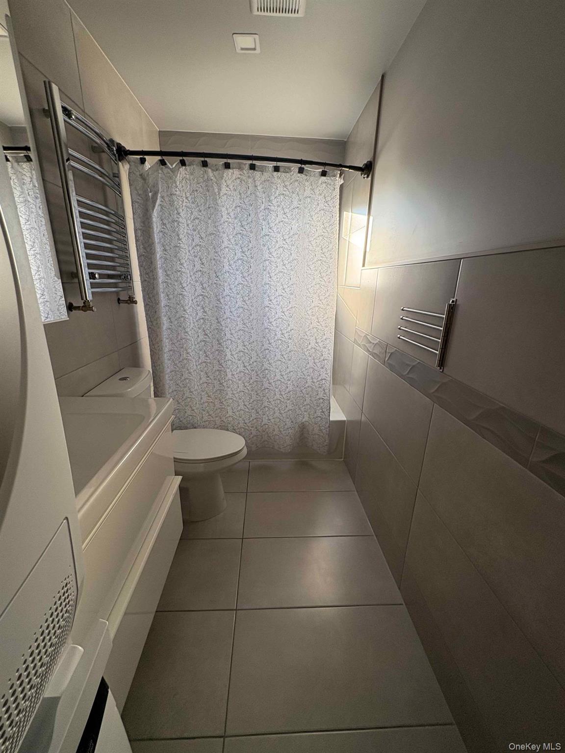 58-46 Fresh Pond Road, Unit 2 Queens, NY 11378 - Photo 9 of 9 a bathroom with a sink a toilet and shower