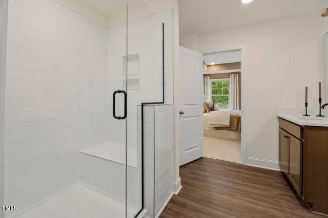 a kitchen with kitchen island a sink and wooden floor