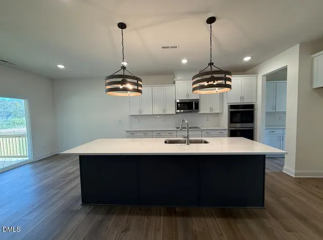 a view of a room with wooden floor