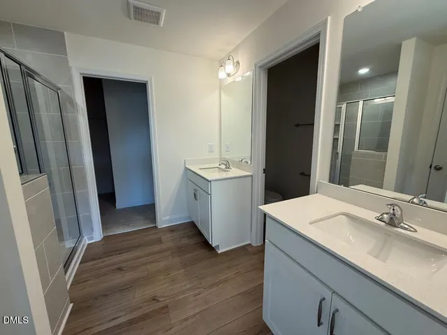 a bathroom with a double vanity sink and mirror