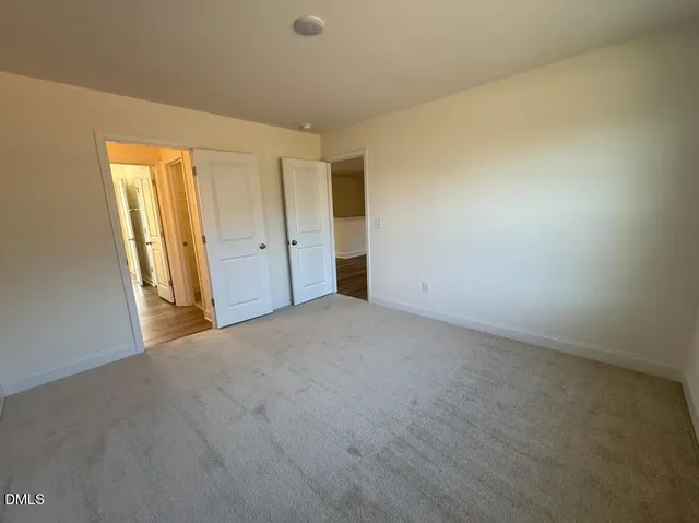a view of a room with wooden floor and cabinets
