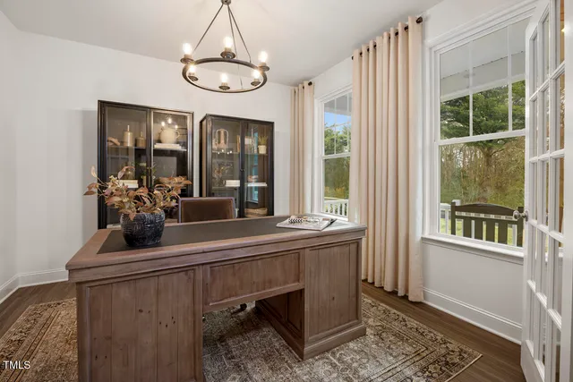 a kitchen with a dining table chairs stainless steel appliances and cabinets