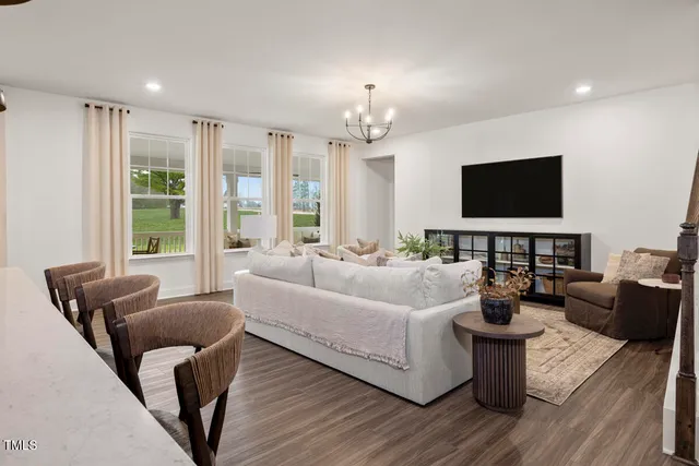 a room with a potted plant on the counter and cabinets