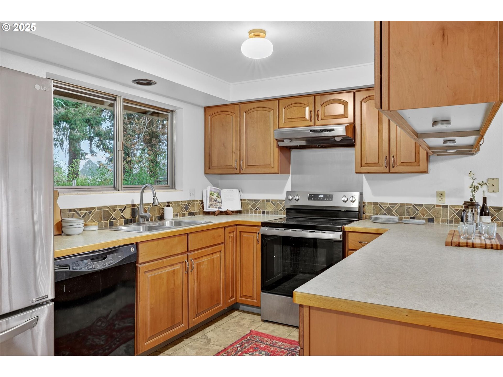 1204 North Elliott Road Newberg, OR 97132 - Photo 13 of 32 a kitchen with a sink stove and cabinets