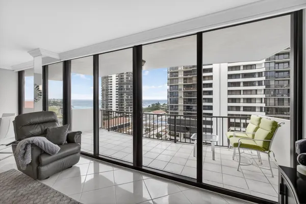 a balcony with chairs and a table