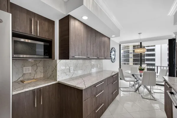 a kitchen with granite countertop a sink and cabinets