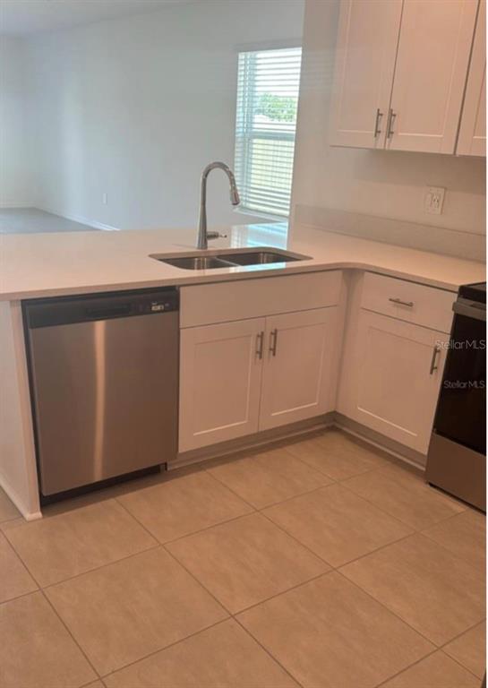 208 Acorn Road Haines City, FL 33844 - Photo 14 of 14 a kitchen with a sink a stove and cabinets
