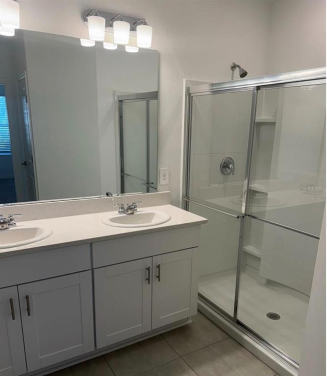 208 Acorn Road Haines City, FL 33844 - Photo 4 of 14 a bathroom with a shower sink and mirror