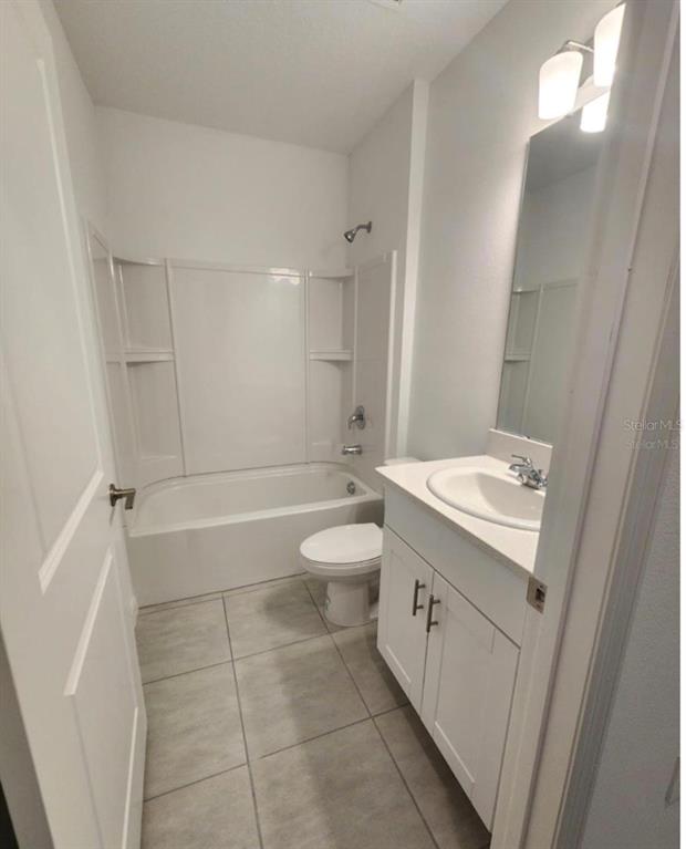 208 Acorn Road Haines City, FL 33844 - Photo 9 of 14 a bathroom with a granite countertop sink a toilet and shower