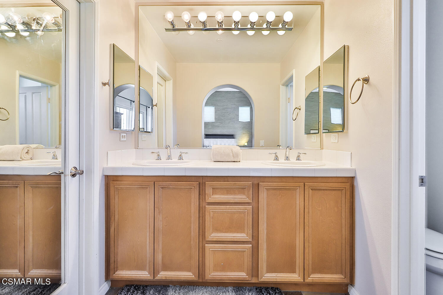 4106 Laredo Lane, Unit A Simi Valley, CA 93063 - Photo 26 of 42 a bathroom with a double vanity sink and a mirror