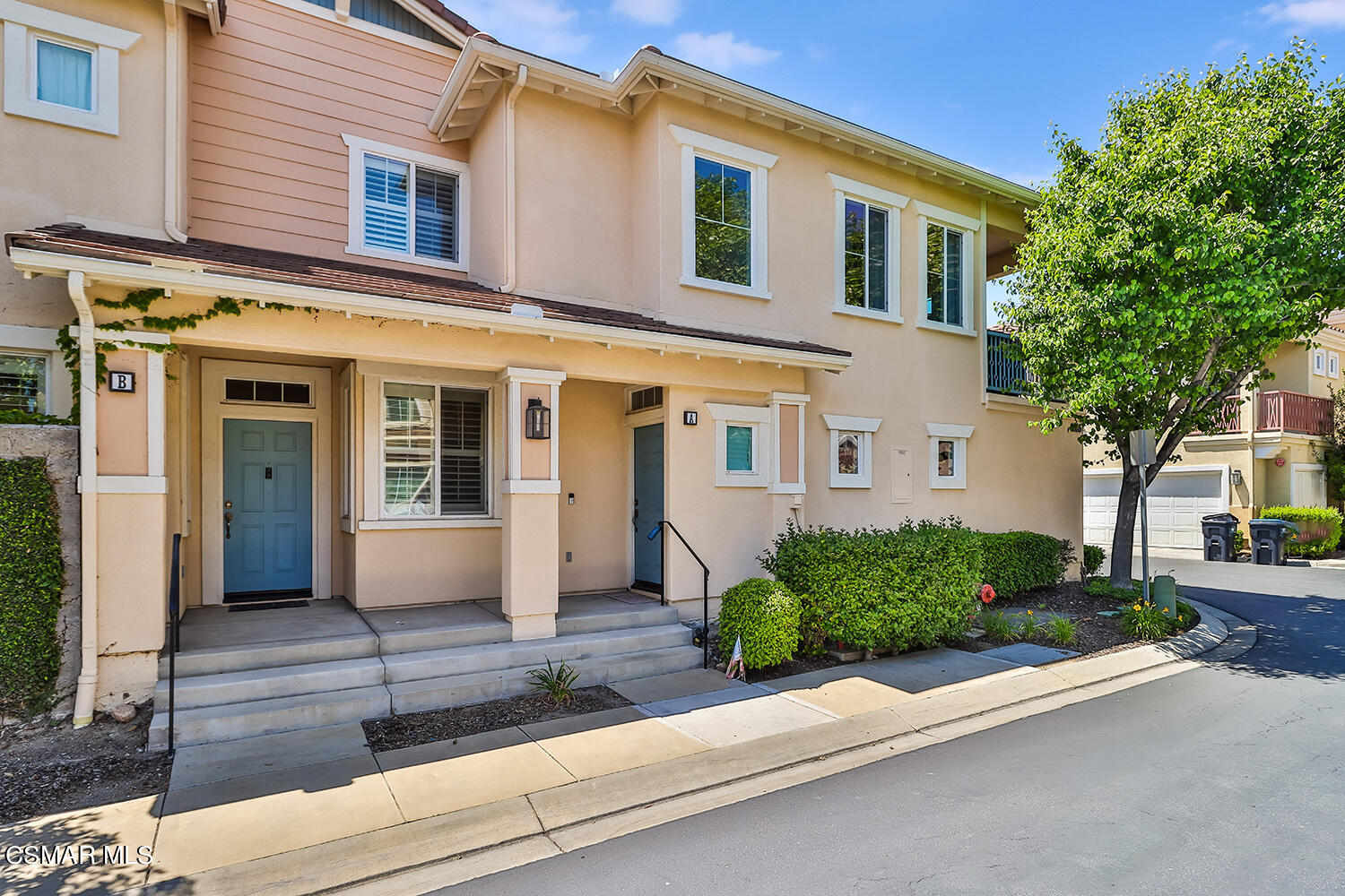 4106 Laredo Lane, Unit A Simi Valley, CA 93063 - Photo 39 of 42 a front view of a house with a yard and potted plants