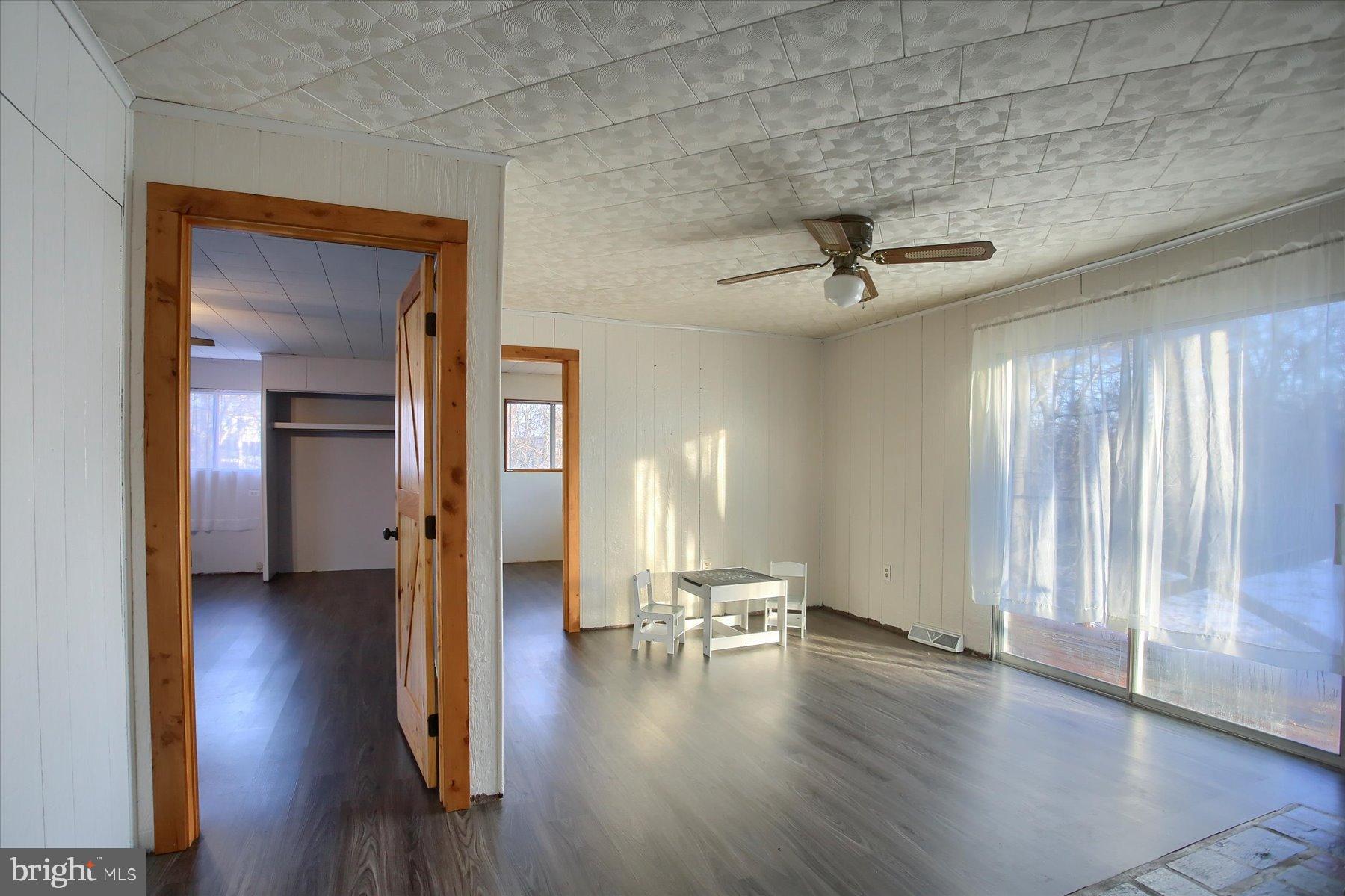 5404 Laurie Lane Enola, PA 17025 - Photo 13 of 29 a view of a livingroom with wooden floor and a ceiling fan