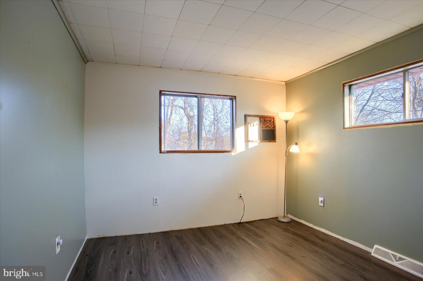 5404 Laurie Lane Enola, PA 17025 - Photo 15 of 29 an empty room with wooden floor and windows