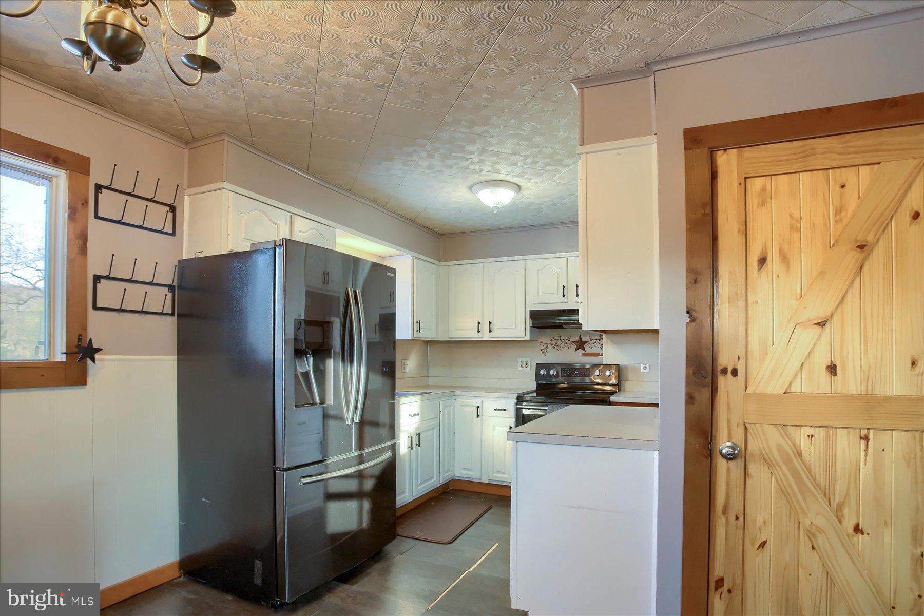 5404 Laurie Lane Enola, PA 17025 - Photo 7 of 29 a kitchen with granite countertop a refrigerator and a stove top oven