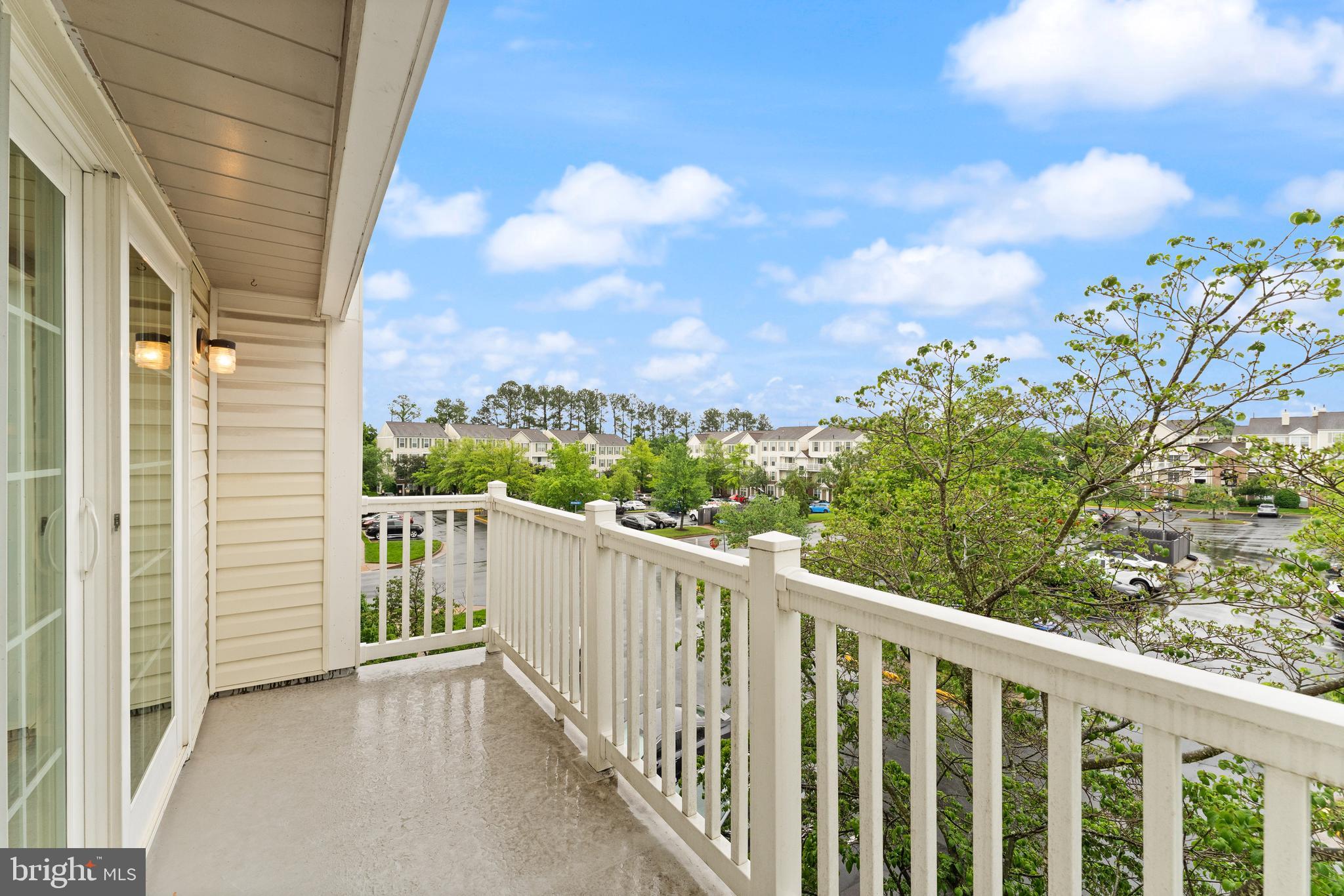 21777 Baldwin Square, Unit 301 Sterling, VA 20164 - Photo 15 of 33 a view of a balcony with wooden fence