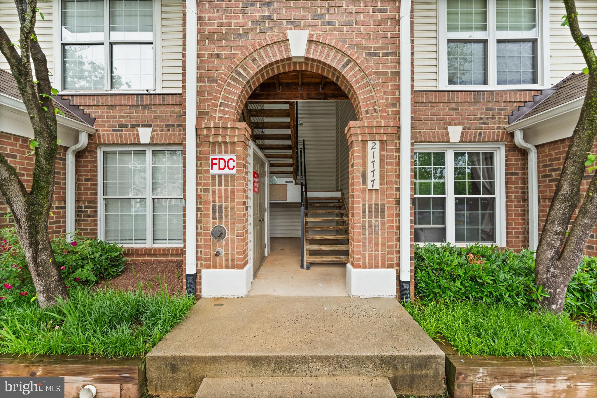 21777 Baldwin Square, Unit 301 Sterling, VA 20164 - Photo 30 of 33 a front view of a house with a yard