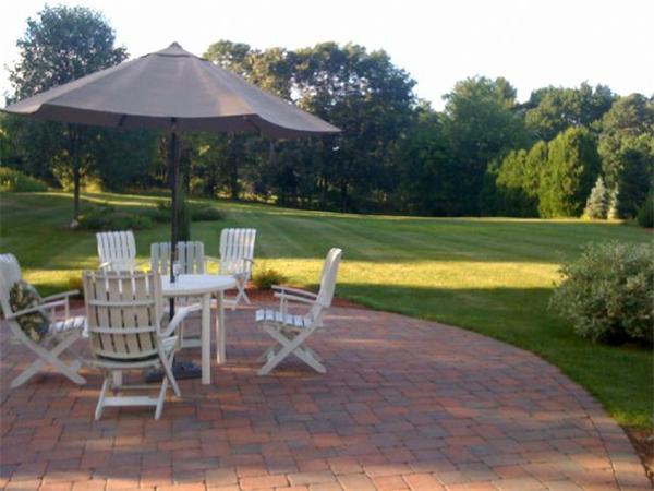 110 Lee Road Deerfield, MA 01373 - Photo 2 of 4 a view of a lake with table and chairs under an umbrella
