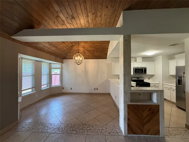 a view of a kitchen with a sink and refrigerator