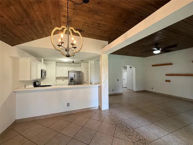 a kitchen with granite countertop a sink and cabinets