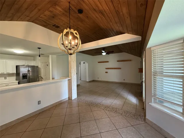 a view of a hallway with chandelier and entryway