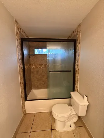 a bathroom with a shower and a toilet