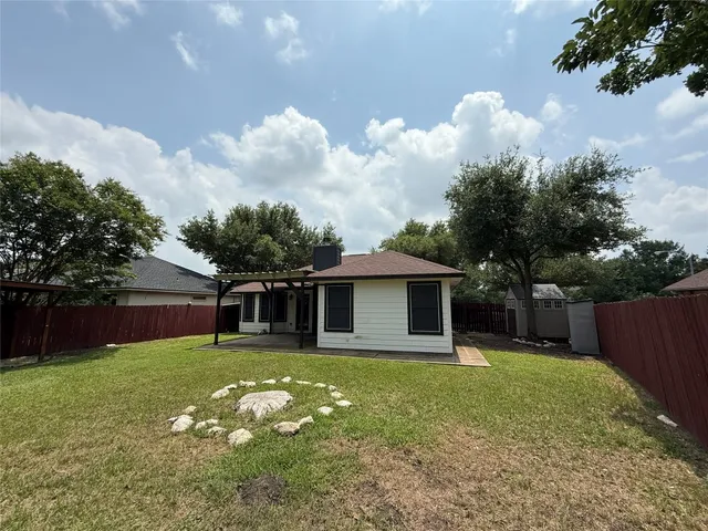 a view of a house with a yard and sitting area