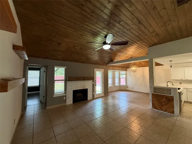 a view of an empty room with a fireplace