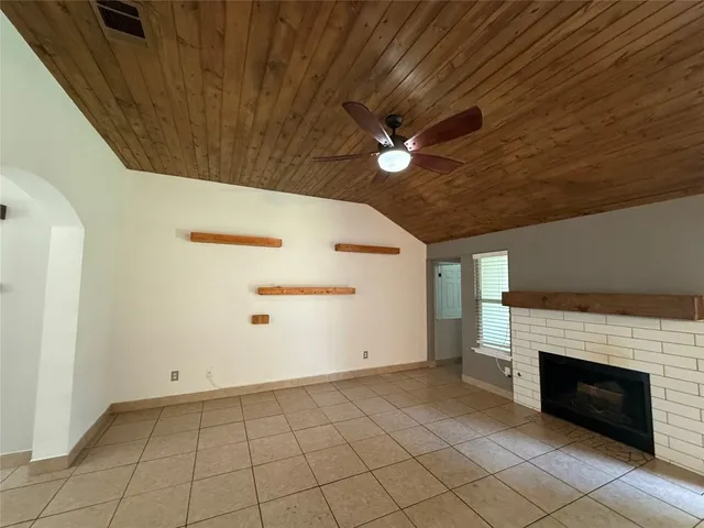 a view of an empty room with a fireplace