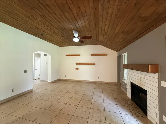 a view of a livingroom with an empty space and a fireplace